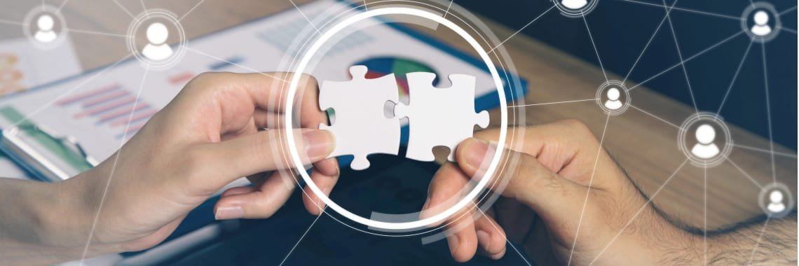 Hands joining puzzle pieces